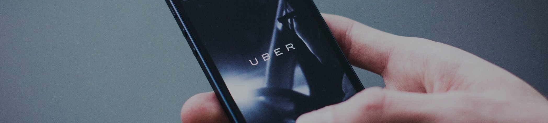 Person using mobile rideshare app for Uber car hire cover